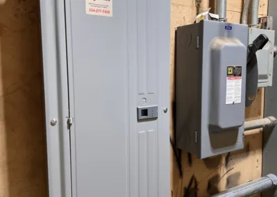 A metal box with electrical equipment attached to it.